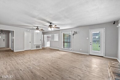 Unfurnished living room with a textured ceiling, c