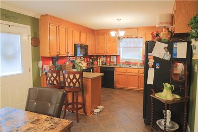 Kitchen - With tile flooring and ample cabinet and counter space.