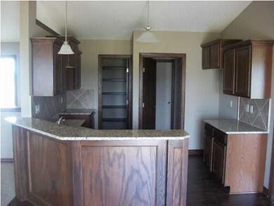 View from kitchen with granite tops, hidden pantry