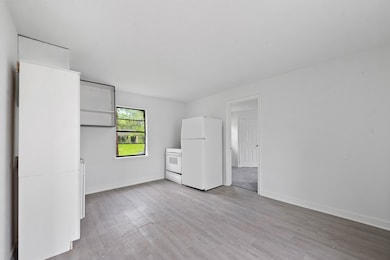 Bright kitchen space with white appliances and cab