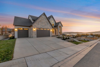 View of front facade featuring concrete driveway, an attached garage, stone siding, and a mountain view