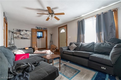 Living room has a large front window for natural lighting.