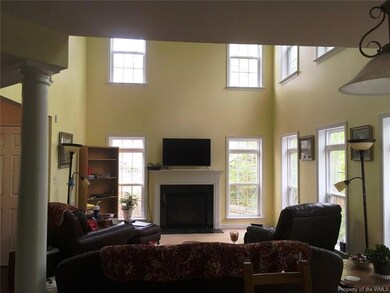 The windows and high ceiling make this living area inviting.