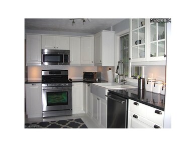 Updated kitchen with granite countertop, porcelain