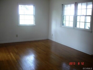 Living Room with new paint & hardwood floors.