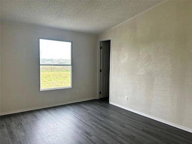 Unfurnished room featuring dark wood-style floors
