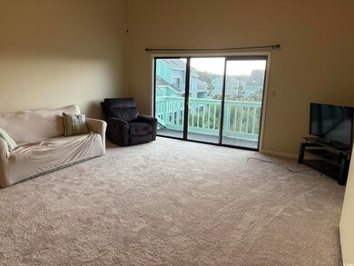 Carpeted living area with baseboards