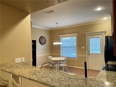 Eating bar overlooks L-shaped kitchen