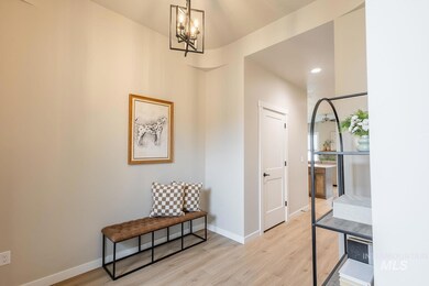 Entrance foyer featuring a chandelier and light wood-style flooring