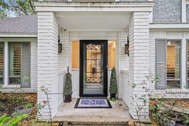 Step into the inviting entrance surrounded by brick columns in neutral color palette, welcoming you into the stunning home.