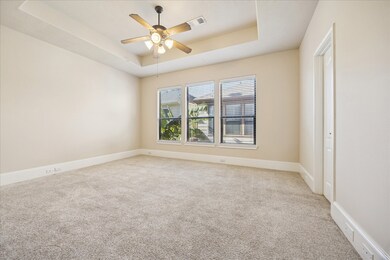 Primary bedroom is generously sized with automatic blinds