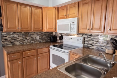 Kitchen featuring a sink, tasteful backsplash, and