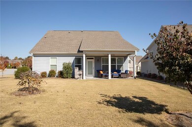 Back of house featuring a patio area, a lawn, an outdoor hangout area, and a shingled roof