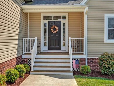 Manicured mulched yard with transom and side light
