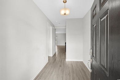 Hall with light hardwood / wood-style floors