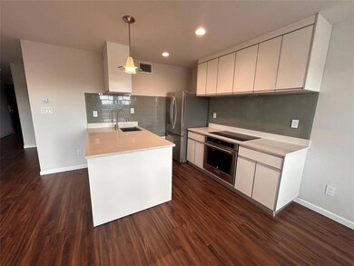 Kitchen featuring stainless steel appliances, lig