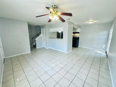 Unfurnished living room featuring ceiling fan, li