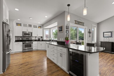 Beverage fridge and peninsula with seating.