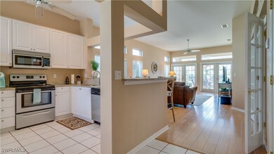 Kitchen with ceiling fan, light stone countertops,