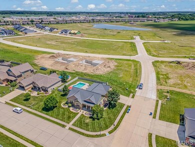Aerial perspective of suburban area featuring a nearby body of water