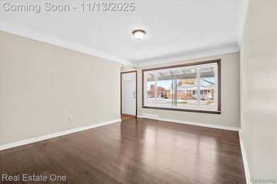 Spare room featuring dark wood-type flooring and a textured ceiling