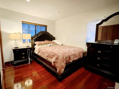 Bedroom with dark wood-style flooring and recessed lighting
