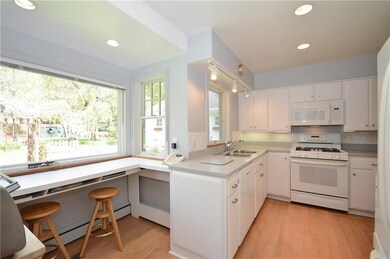 Light and bright kitchen with gleaming hardwood fl