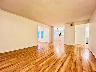 Spare room featuring light wood-style floors and a textured ceiling