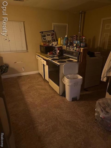 Kitchen featuring range and white cabinets