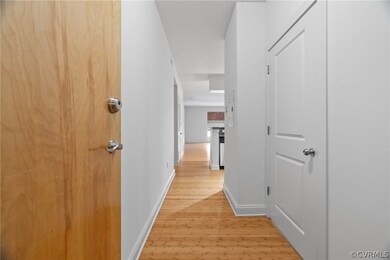 Hallway with light wood-type flooring