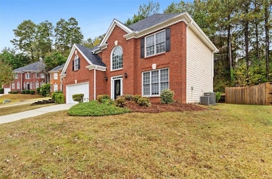 View of front of property featuring driveway, a garage, and brick siding