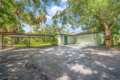 View of front of house with a carport and a garage