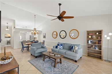 Living area with baseboards, high vaulted ceiling,
