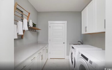 Washroom featuring cabinet space and washing machine and dryer