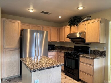 Kitchen featuring black appliances, ventilation ho