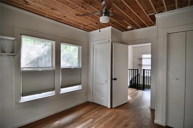 Empty room featuring ceiling fan, wood finished f