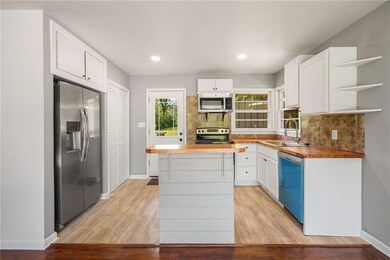 Kitchen featuring stainless steel appliances, a si