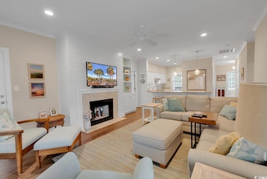 Living room with ceiling fan, light hardwood / woo