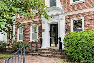 Doorway to property featuring brick siding