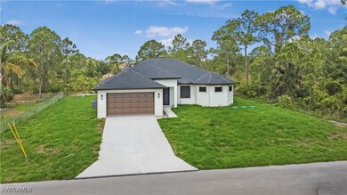 View of front facade with driveway, a garage, and