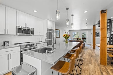 Kitchen featuring light wood finished floors, a si