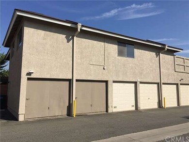 the two garages with wooden garage doors belong to