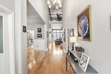 Foyer entrance with blonde wood floors and through