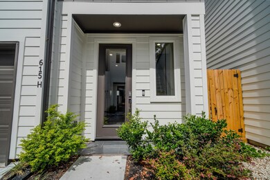 Inviting covered entry with modern design and clean lines. Low-maintenance landscaping adds charm to the front walkway.