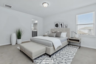 Bedroom with finished concrete floors, baseboards