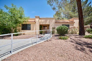 Pueblo-style house with stucco siding