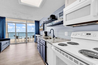 Kitchen featuring floor to ceiling windows, a sink