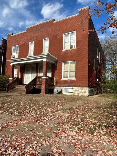 Traditional-style house with brick siding and covered porch