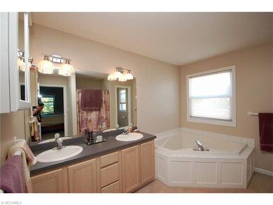 A dual sink vanity, garden tub, stand up shower an
