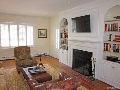 Family room with view of fireplace and built-in bo